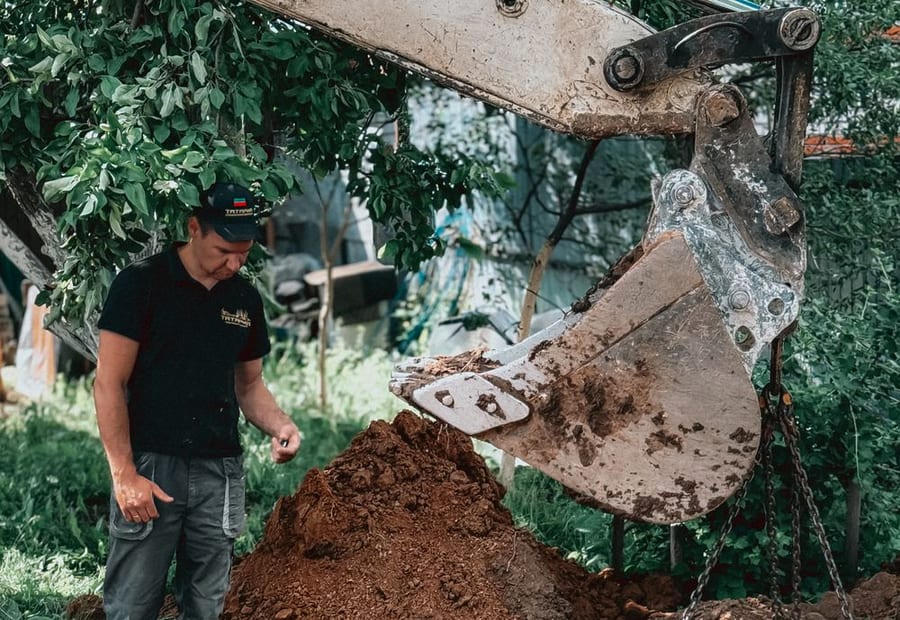 New septic tank and pump chamber being set into an excavation on a rural Olmsted County lot near Rochester, Minnesota